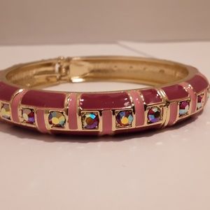 Pink enameled bracelet with gold colored inlay